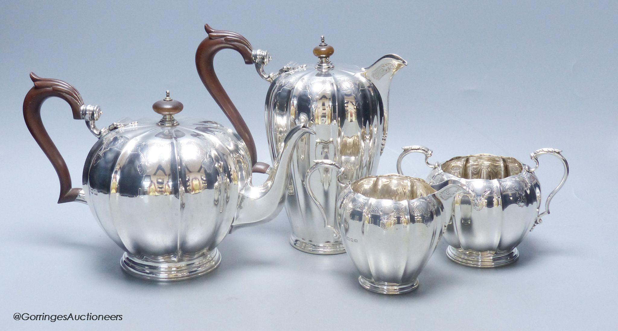 A George V engraved fluted silver four piece silver tea set by Adie Bros, London, 1923,27,28